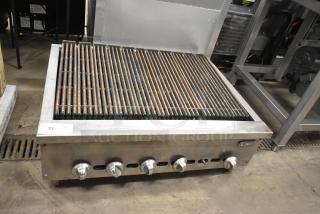 Jade Stainless Steel Commercial Charbroiler Grill, gas-powered, with five control knobs, slight wear, model tag visible.