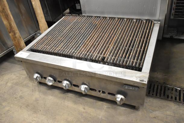 Jade stainless steel gas charbroiler grill, commercial countertop model, five control knobs, visible logo, good condition.