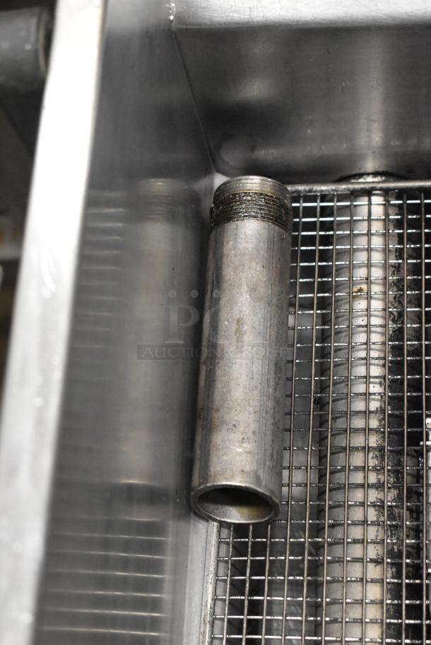 Asber stainless steel commercial deep fat fryer, features durable construction and grid interior, showing light use signs.