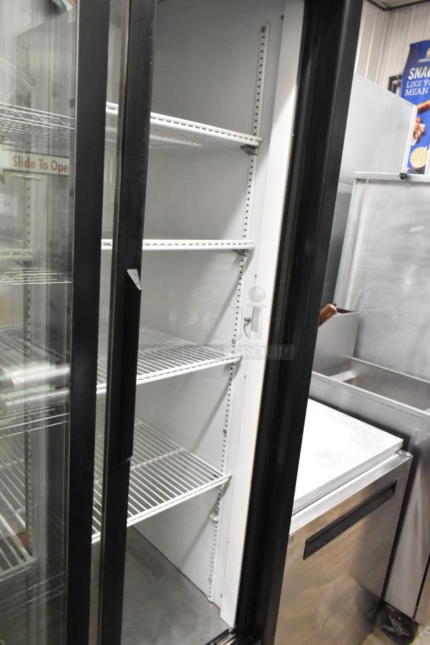 True GDM-33 commercial cooler with two glass doors, poly-coated racks, and casters. Excellent condition, 115V, single phase.