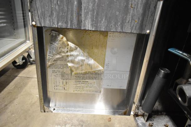 Cook Rite stainless steel commercial gas fryer, floor style, on casters. Visible wear, operation instructions on panel.