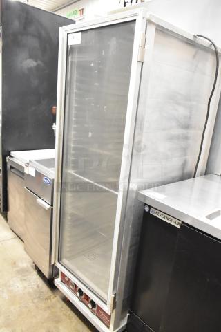 Win-holt metal commercial heated holding cabinet on casters, 120 volts, 1 phase, in good condition with glass door.