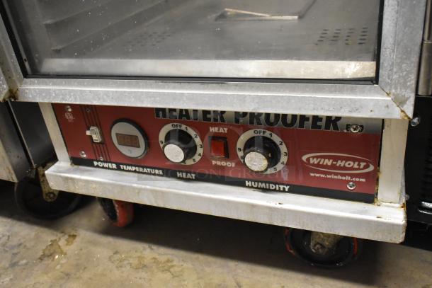 Win-holt metal commercial heated holding cabinet with controls; 120 volts, 1 phase. Equipped with commercial casters.