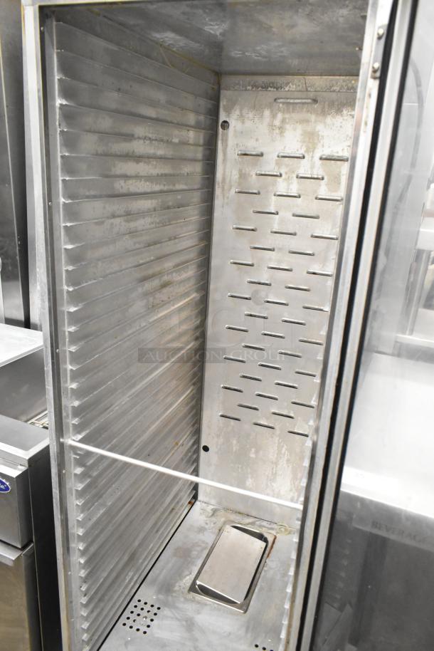 Win-holt metal commercial heated holding cabinet with commercial casters, 120 volts, 1 phase, interior view, used condition.