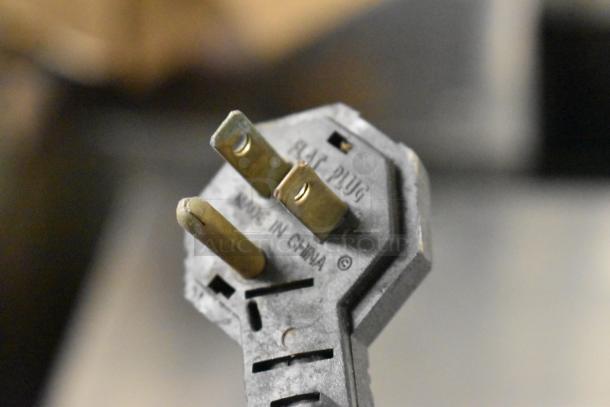 Close-up of a plug labeled “Flat Plug, Made in China.” For a Manitowoc QM45A ice machine, 115 volts, 1 phase.