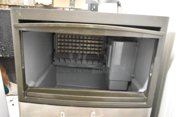 Manitowoc QM45A ice machine, stainless steel, undercounter, self-contained, 115V, 1 phase, used condition, open compartment view.