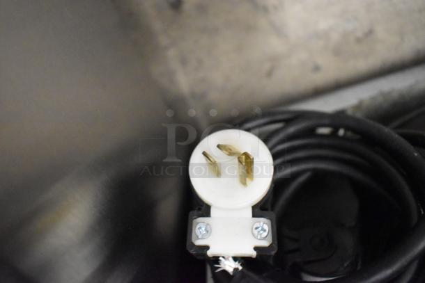 Close-up of a plug and power cord for a 2020 Delfield 406P-STAR4 stainless steel undercounter cooler, 115 Volts, 1 Phase.