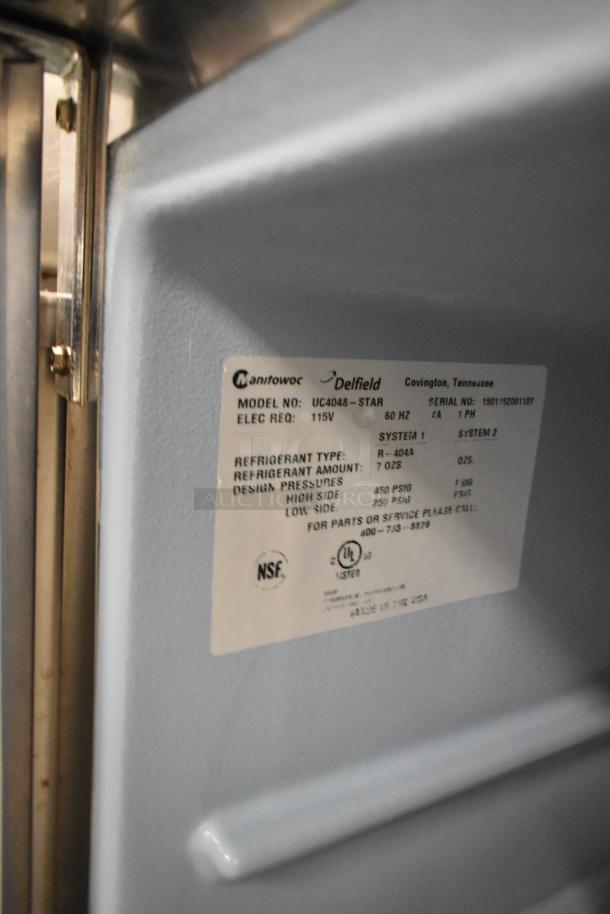 Delfield UC4048-STAR stainless steel 2-door undercounter cooler, 115 volts, with visible label detailing model and refrigerant specs.