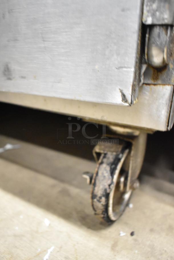 Alto Shaam 750-S stainless steel heated holding cabinet on worn commercial caster, 125V, 1 phase.
