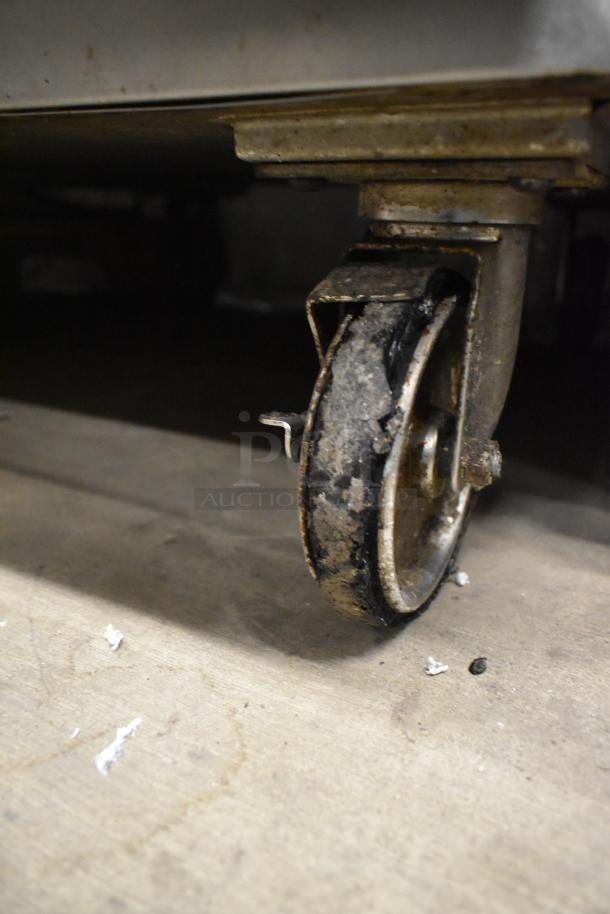 Alto Shaam 750-S commercial heated cabinet on worn caster. Stainless steel, 125V, 1 phase.