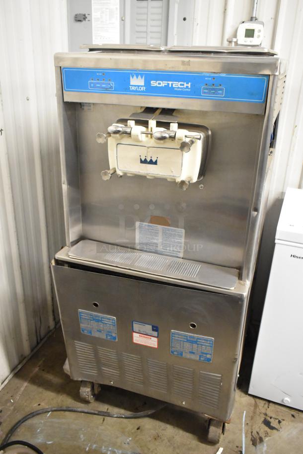 Taylor 754-27 stainless steel 2-flavor twist soft serve machine. Commercial casters. Good condition. 208-230V, 1 phase.
