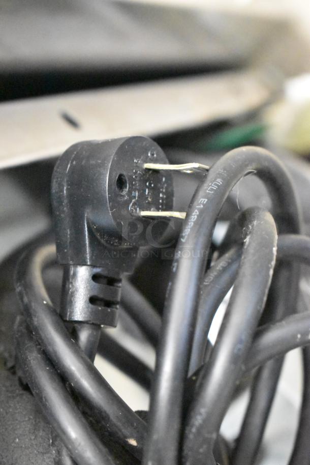Close-up of a black power cable and plug for a Delfield 406P-STAR2 undercounter cooler, 115 volts, 1 phase.