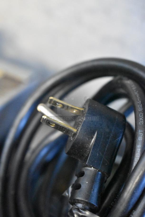 A close-up of a 115-volt power cord for the 2020 Delfield 406P-STAR2 commercial cooler, showing a grounded plug.