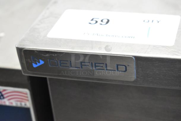 2021 Delfield 406P stainless steel undercounter cooler, single door, on commercial casters. Visible Delfield logo.