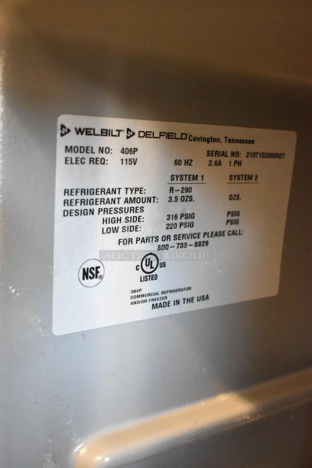 2021 Delfield 406P stainless steel undercounter cooler on casters; 115V, 1 phase. Model label shows refrigerant R-290, NSF, UL listed.