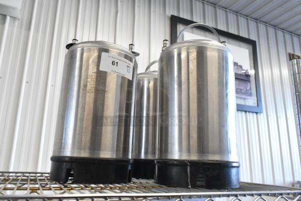 Three stainless steel home brew kegs on metal shelf, slightly used condition. Auction lot label with "61" and "QTY X3".