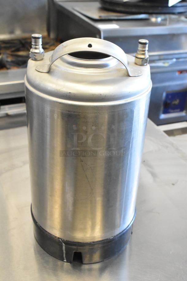 Stainless steel home brew keg with metal handle and taps; used condition. Part of a lot of 3 kegs up for auction.