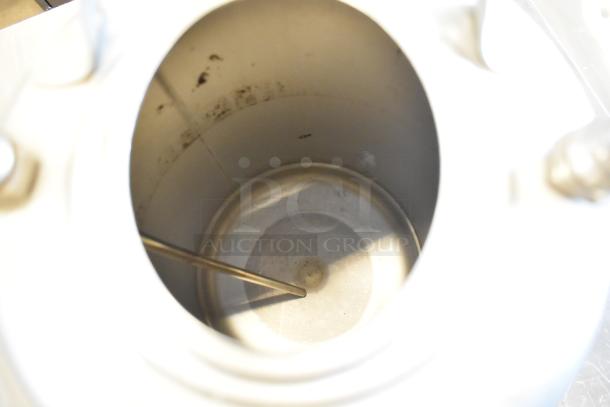 Three metal home brew kegs, interior view, showing clean, polished surface with minor residue. No visible labels or markings.