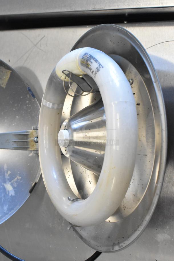 Circular Pelsis light fixture, metallic finish, with visible tube lamp; condition shows light wear.