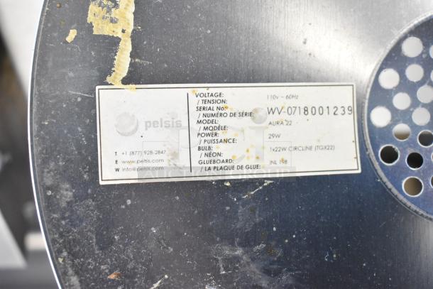 Pelsis Aura 22 light fixture, 110V, 29W, model WV-0718001239, with visible wear and adhesive residue on label.
