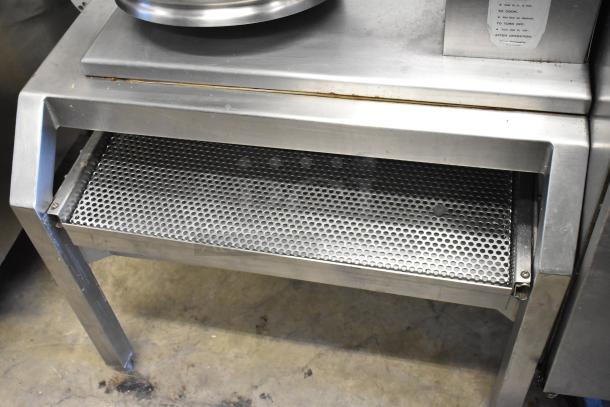 Groen stainless steel commercial electric steam kettle, 208/240 volts. Features sturdy stand and perforated shelf, good condition.