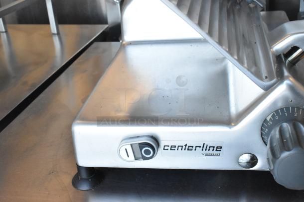 2022 Hobart Centerline EDGE12-11 stainless steel meat slicer with sharpener, featuring power switch, 115V, excellent condition.