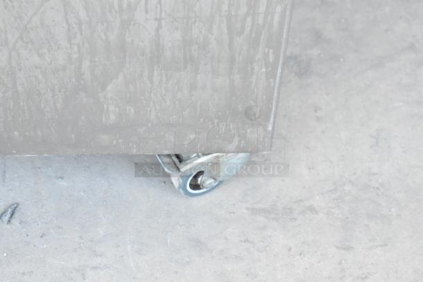 Stainless steel panel and caster wheel of Jun-Air 87R-4MN1-HSBHH nitrogen generator, designed for commercial use.