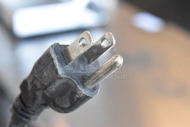 Close-up of a three-pronged electrical plug for a Jun-Air 87R-4MN1-HSBHH Nitro Brew Nitrogen Generator, 120V.