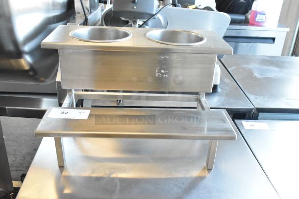 Stainless steel countertop stand with two wells, excellent condition, features durable construction and sleek design. Auction label visible.