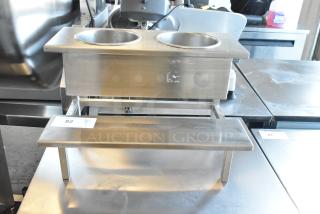 Stainless steel countertop stand with two wells, excellent condition, features durable construction and sleek design. Auction label visible.