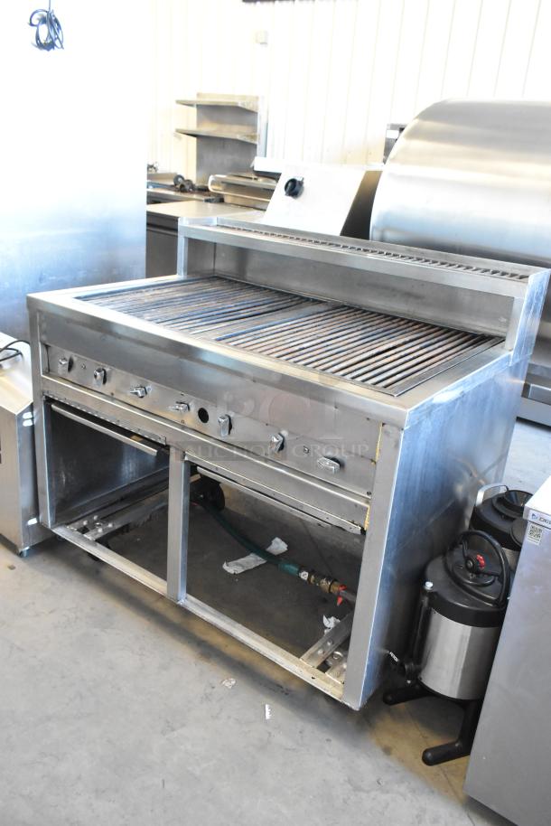 Stainless steel commercial charbroiler grill on casters, features temperature knobs, open storage below, excellent condition.
