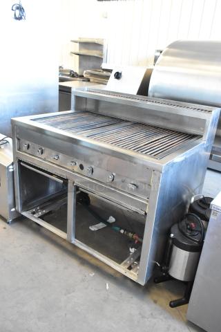 Stainless steel commercial charbroiler grill on casters, features temperature knobs, open storage below, excellent condition.