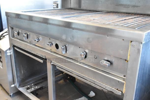 Stainless steel commercial charbroiler grill, multiple knobs, on casters for mobility. Good condition.