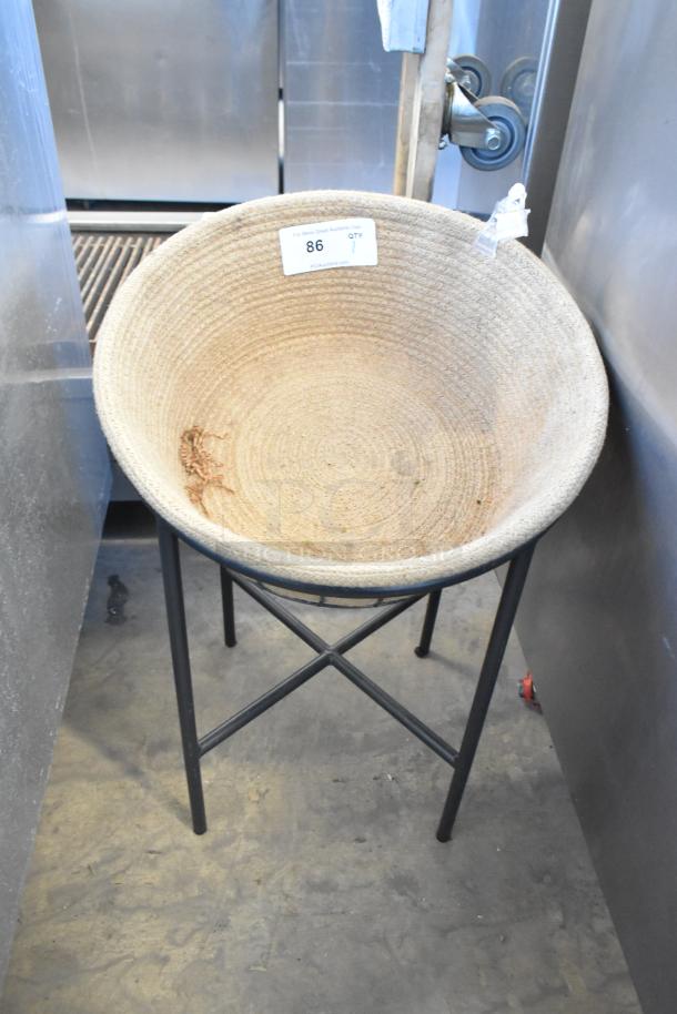 Basket on metal stand with 3 commercial casters, woven design, item tag marked "86 QTY 1," good condition.