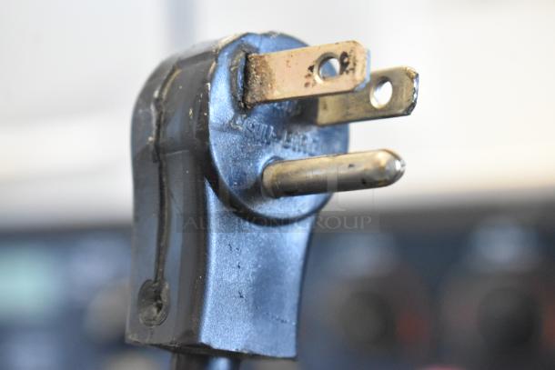 Close-up of a power plug for the Traulsen G12000 commercial freezer. Plug shows standard three-prong design.
