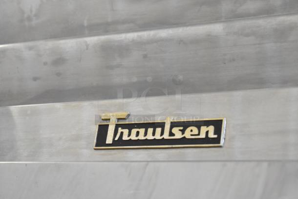 Traulsen RHT132WREHHS stainless steel commercial cooler, 2 half doors, metal racks, 115V, 1 phase, logo detail shown.
