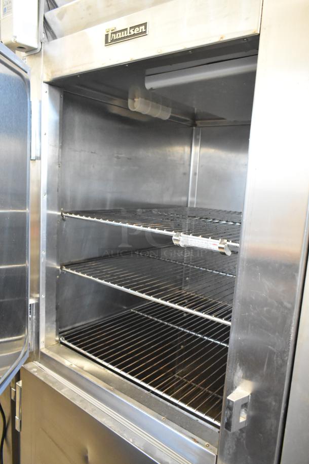 Traulsen RHT132WREHHS stainless steel 2 half-door cooler with metal racks, good condition, 115V, 1 phase.