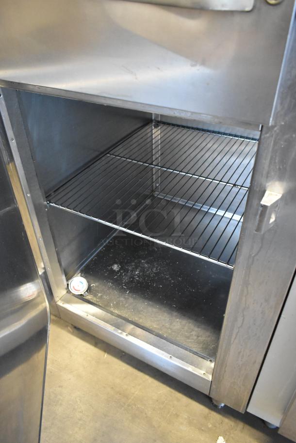 Traulsen RHT132WREHHS stainless steel cooler, 2 half-size doors, metal racks, temperature gauge, 115V, commercial use.