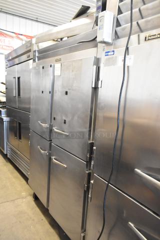 Traulsen RHT 2-32NUT stainless steel reach-in cooler with four half-size doors, metal racks, and commercial casters.