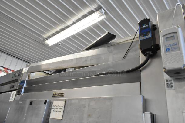 Traulsen RHT 2-32NUT stainless steel 4 half-door reach-in cooler on casters, visible control panel and labels, 115V, 1 phase.