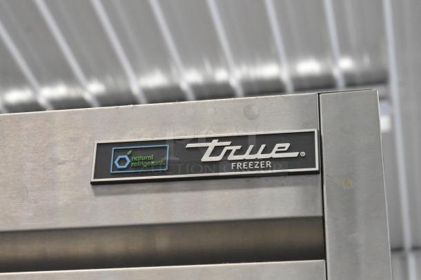 2021 True T-49DT-4-HC stainless steel commercial freezer, four half doors, metal racks, commercial casters, natural refrigerant label.