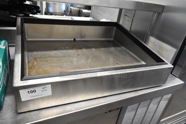 Metal bin with a sticker indicating auction lot number 100, showing signs of use and wear.