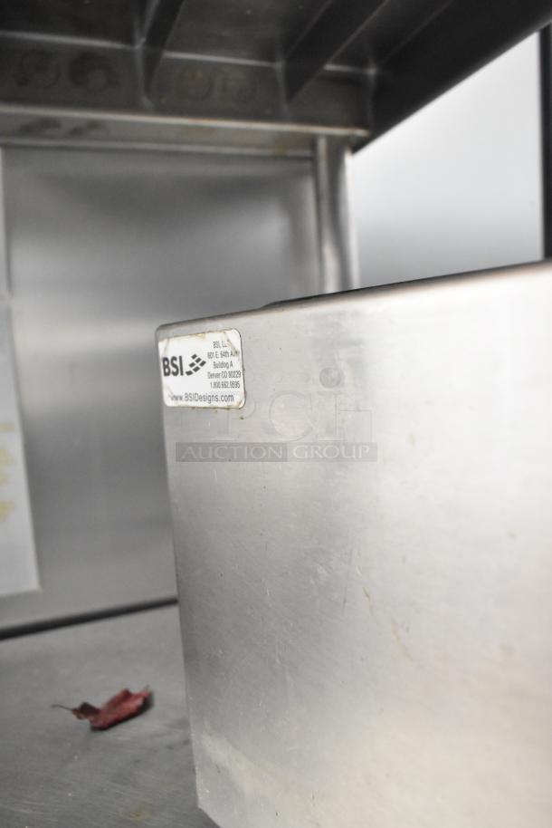 Metal bin with BSI label, mild wear. Includes cutting board drying rack. Auction doubles your bid.