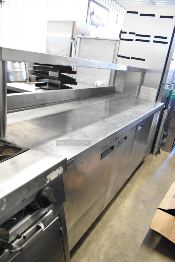 Delfield stainless steel commercial 3-door work top cooler with over shelf, 115 volts, 1 phase. Good condition.
