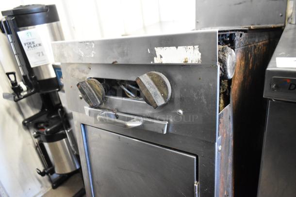 Southbend stainless steel gas 2-burner range with 2-tier overshelf and backsplash on casters, showing wear.