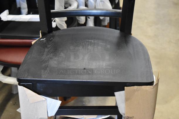 14 new Lancaster Table & Seating black ladder back bar height chairs with minor scratches and dents, packaging visible.