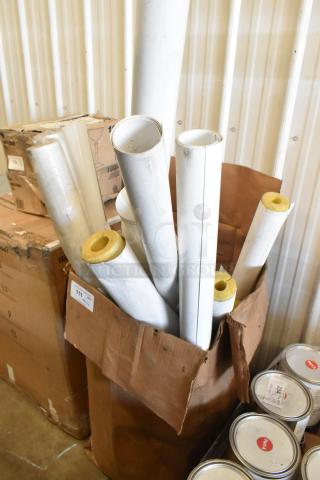Assorted white tubes in a cardboard box, varying lengths, with some insulation visible. Auction items, 20 tubes total.