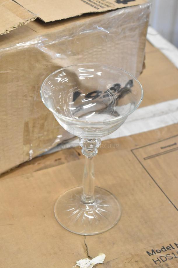 Two boxes of 12 Libbey 1924 4.75oz wine/cocktail glasses, new, with 4 glasses missing. Visible scratch and dent on boxes.