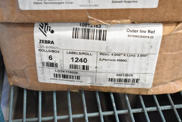 Three boxes of Zebra labels, each with 6 rolls of 1,240 labels. Labels measure 4" x 2". Made in USA, Z-Perform 2000D.