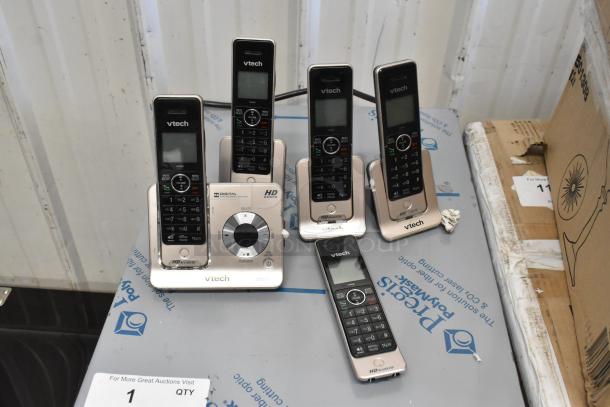 Auction lot with VTech phone set, including five handsets and base, in good condition.